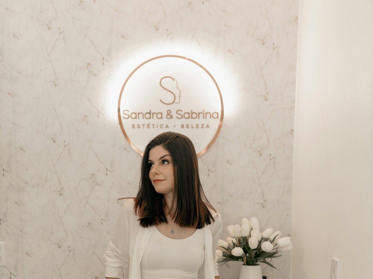 Woman with short dark hair standing in a bright studio space